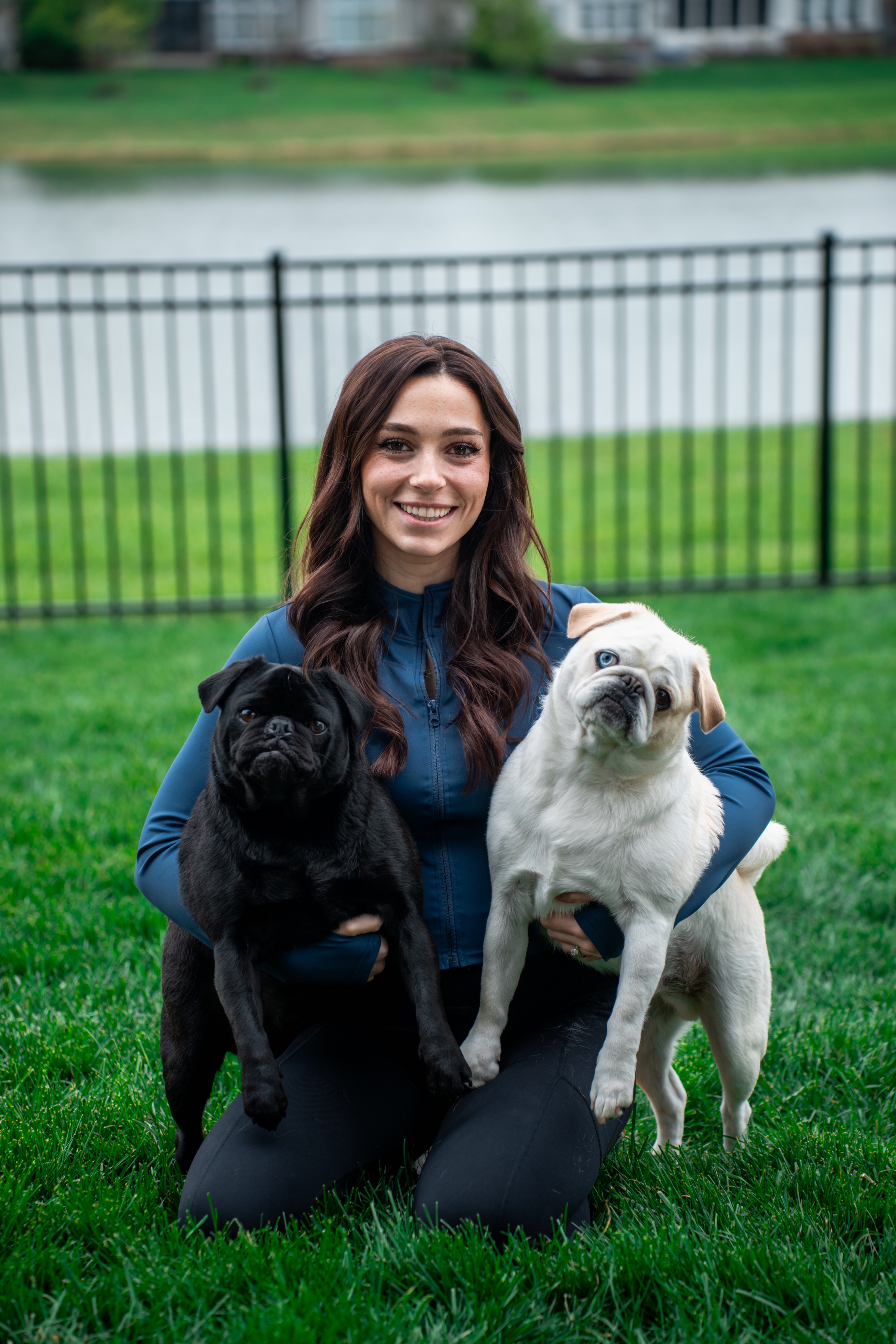 Mia, founder of The Canine Gym, with her two pugs
